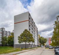 Apartment buildings on Komenského Street in Modra surrounded by greenery and cars.