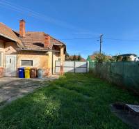 Family house in Ludanice with a lawn and a concrete terrace in the backyard.