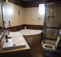 A bathroom with a bathtub, shower, and sink in a 3-room apartment, elegant design.