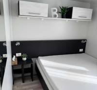 Minimalist bedroom with hanging cabinets and a wooden decor floor in unique properties.