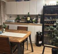 Dining area with a wine cooler and decorations, floor with wooden decor. Unique properties.