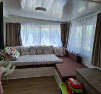 A room in unique real estate with comfortable seating and a floor with wood decor.