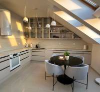 Bright kitchen with a dining table in a 3-room apartment, cozy attic.