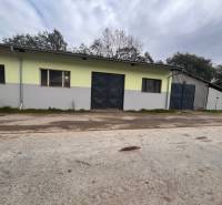 Warehouses and halls in Olešná, a building with a gate and windows, outdoor space.