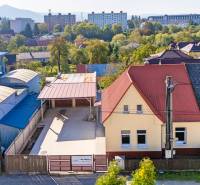 A family house on Sklárska Street in Lednické Rovne surrounded by greenery and buildings.