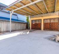 Covered concrete area and garage at the family house on Sklárska Street in Lednické Rovne.