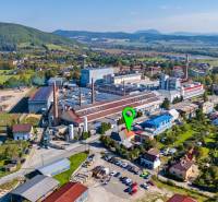 Aerial view of an industrial area with houses in Lednické Rovne on Sklárska Street.