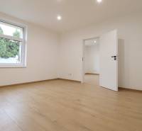 A room in a family house with a window and a wooden decor floor.