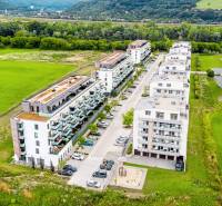 Púchov, exterior with apartment buildings and greenery, suitable for a 2-room apartment.