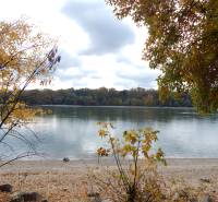 Autumn by the river in Radvaň nad Dunajom, surrounded by colorful trees and a pebble beach.