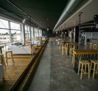 Stylish gastro spaces with wooden decor, modern furniture, and glass walls.