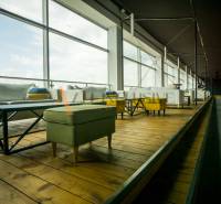 Comfortable seating with a wooden decor floor and large windows in dining areas.