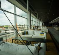 Spacious gastro spaces with comfortable seating and wooden decor flooring.