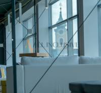 Interior seating with a view of the church, modern lighting, wooden decor flooring.