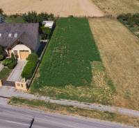 A family house with a large plot for living in Práznovce, surrounded by greenery and fields.