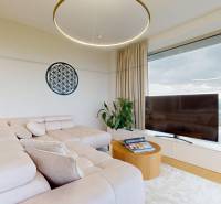 Living room with a light sofa, circular chandelier, and view in a 4-room apartment.