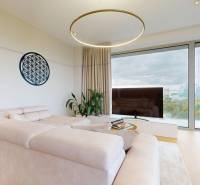 Living room with a sofa, wooden decor flooring, and a large window in a 4-room apartment.