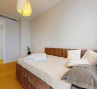 A bedroom in a 4-room apartment with a comfortable bed and a floor with a wooden decor.