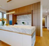 Dining area with a table and chairs, wooden decor flooring, view outside.