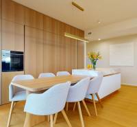 Dining area with a wooden table, six chairs, and a floor with a wooden decor.
