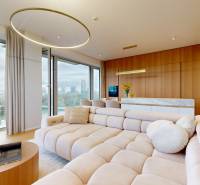 A bright living room with a spacious beige sofa and panoramic windows in a 4-room apartment.