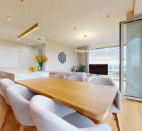 A bright dining room with a table and a wooden decor floor in a 4-room apartment.