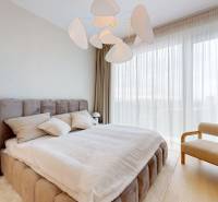 Bedroom in a 4-room apartment with a large bed and designer lighting, floor with wood decor.