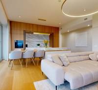 Living room with kitchen, wooden floor decor, and beige sofa in a 4-room apartment.
