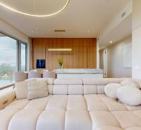 Living room in a 4-room apartment with a large window, sofa, and decorative pillows.