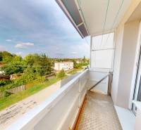 A balcony of a 4-room apartment in Horné Obdokovce with a view of the green surroundings.
