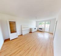 A room in a 4-room apartment with a wooden decor floor and furniture.