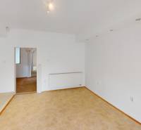 Interior of a family house with white walls and a floor with a wood decor.