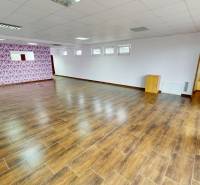 Interior of a family house with a wooden decor floor and floral wallpaper.