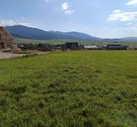 A plot for housing in Stránske with a view of the surrounding landscape and construction.