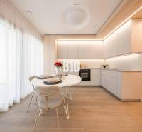 A kitchen in a 3-room apartment with white furniture and a wooden decor floor.