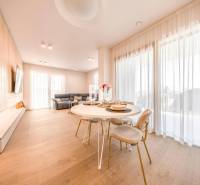 Living room in a 3-room apartment with a wood-patterned floor, dining table, and sofa.