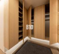 A wardrobe with wooden doors and a floor with a wooden decor in a 3-room apartment.