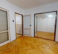 Interior of a 3-room apartment with doors and flooring featuring a wood design.