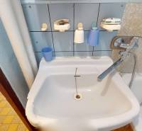 Bathroom in a 3-room apartment with a sink, bathtub, and tiled floor.