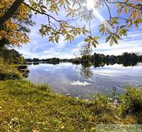 The lake near Malé Leváre with the gently setting sun and autumn nature.