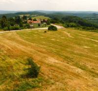 Agricultural and forest lands in Cerová with a visible village surrounded by green hills.
