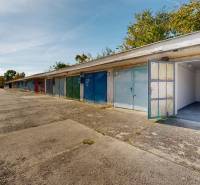 Open garages on Akademika Jozefa Čabelku Street in Holíč with a variety of colorful doors.