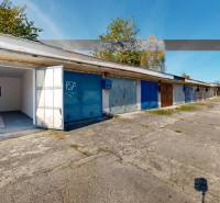 Garages on Akademika Jozefa Čabelku Street in Holíč, concrete surface, open garage door.