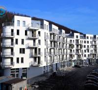 A new apartment building on the street in Trenčianske Teplice with numerous balconies and parking space.