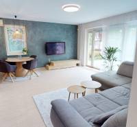 Living room in a family house with a corner sofa and a floor with a wooden decor.