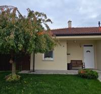 The family house on Lotosova in Malinovo has a landscaped garden with a large tree.