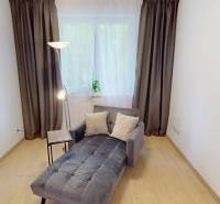 The interior of a family house with a comfortable lounger, a lamp, and a floor with a wooden decor.