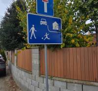 Traffic signage on Lotosová Street in Malinovo near family houses.