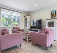 A living room with pink sofas and a television in a family house.