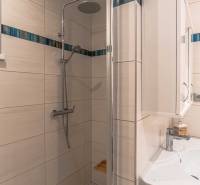 Bathroom with a shower and sink in a family house.